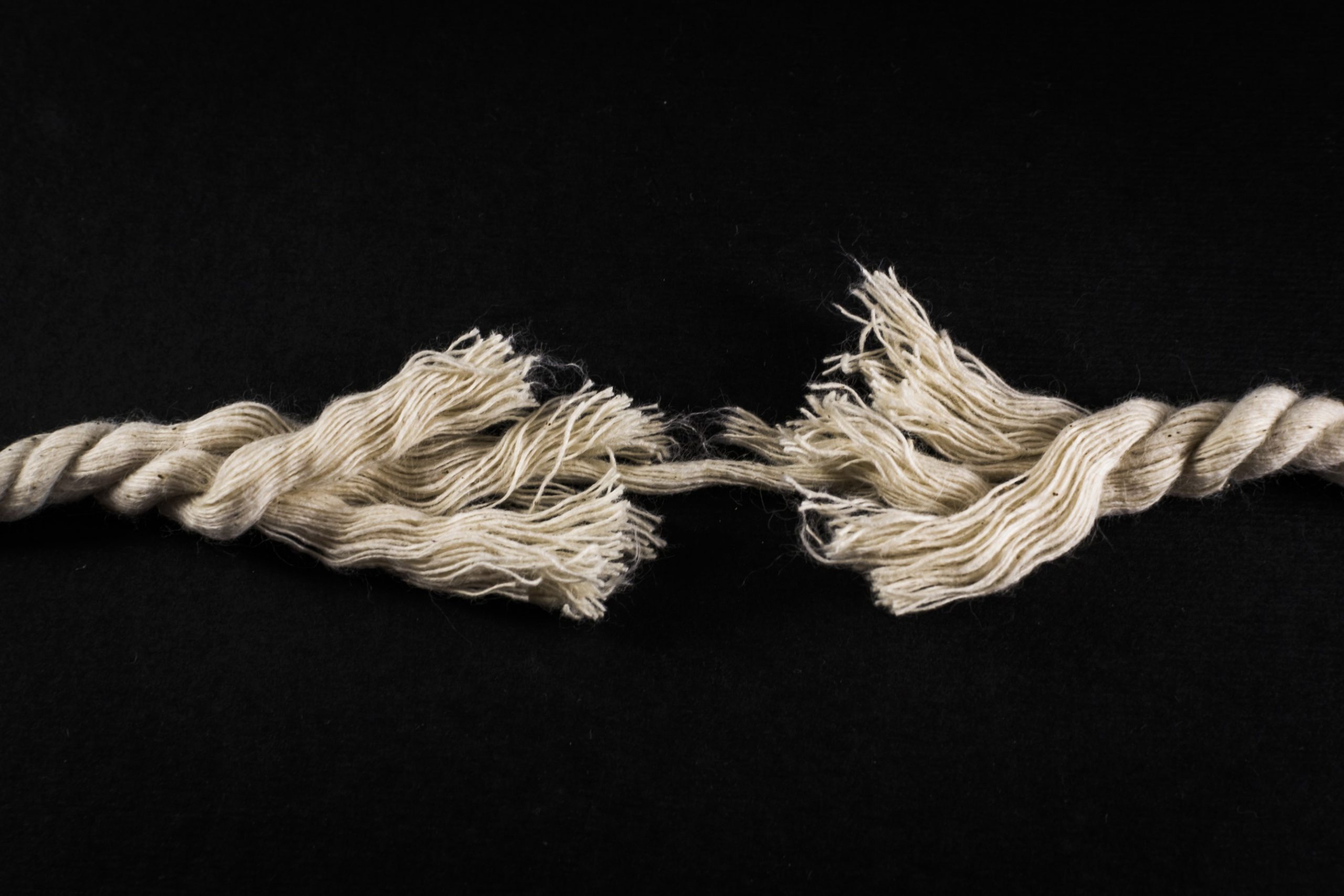 Frayed Rope and Thread on Black Background - Unlocking the Gold